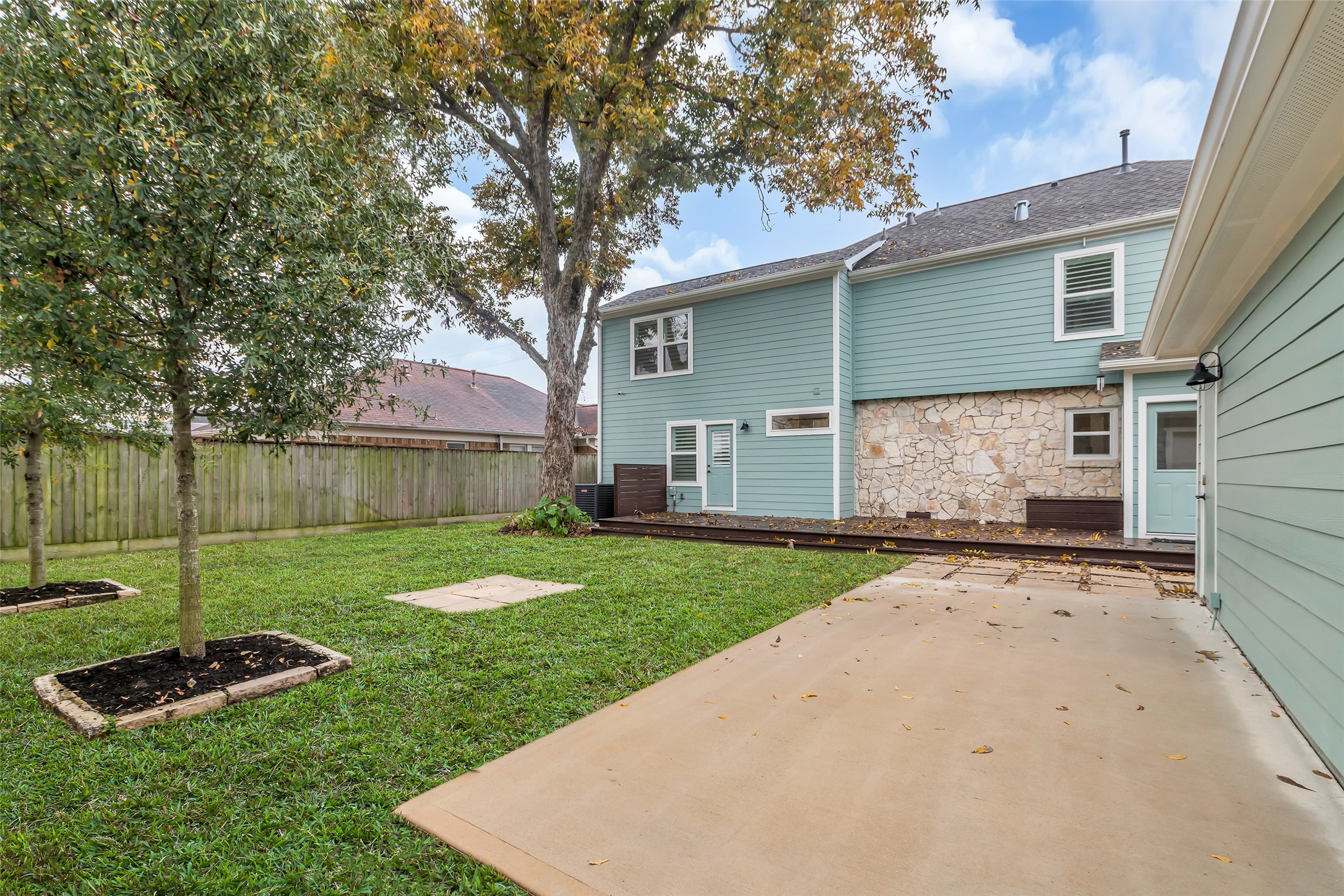 2611 Ruth Street Houston, TX 77004 - Photo 44 of 50 This view from the side of the detached garage shows more of the backyard, highlighting the open space and landscaping.