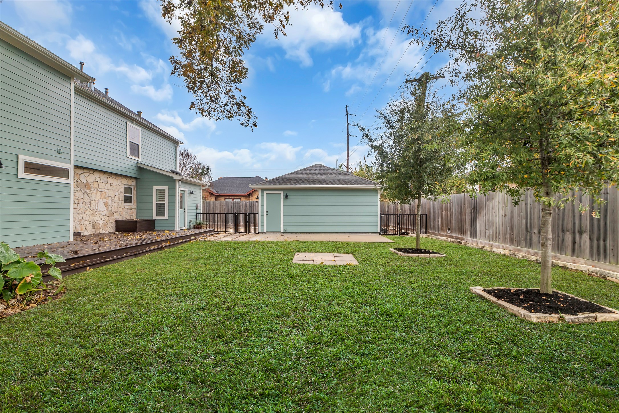 2611 Ruth Street Houston, TX 77004 - Photo 46 of 50 A wider view of the backyard reveals two Water Oaks and the garage at the far end.