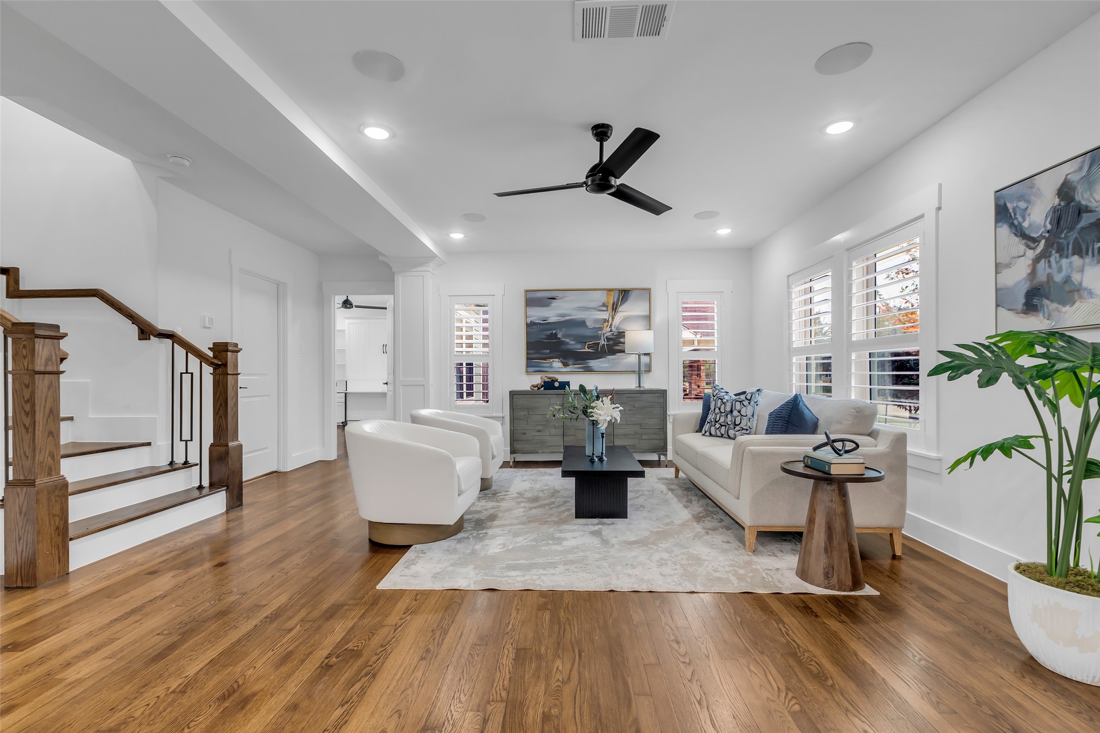 2611 Ruth Street Houston, TX 77004 - Photo 4 of 50 The living room is filled with natural light and features the original hardwood flooring, creating a warm and open feel that suits both relaxing and entertaining.