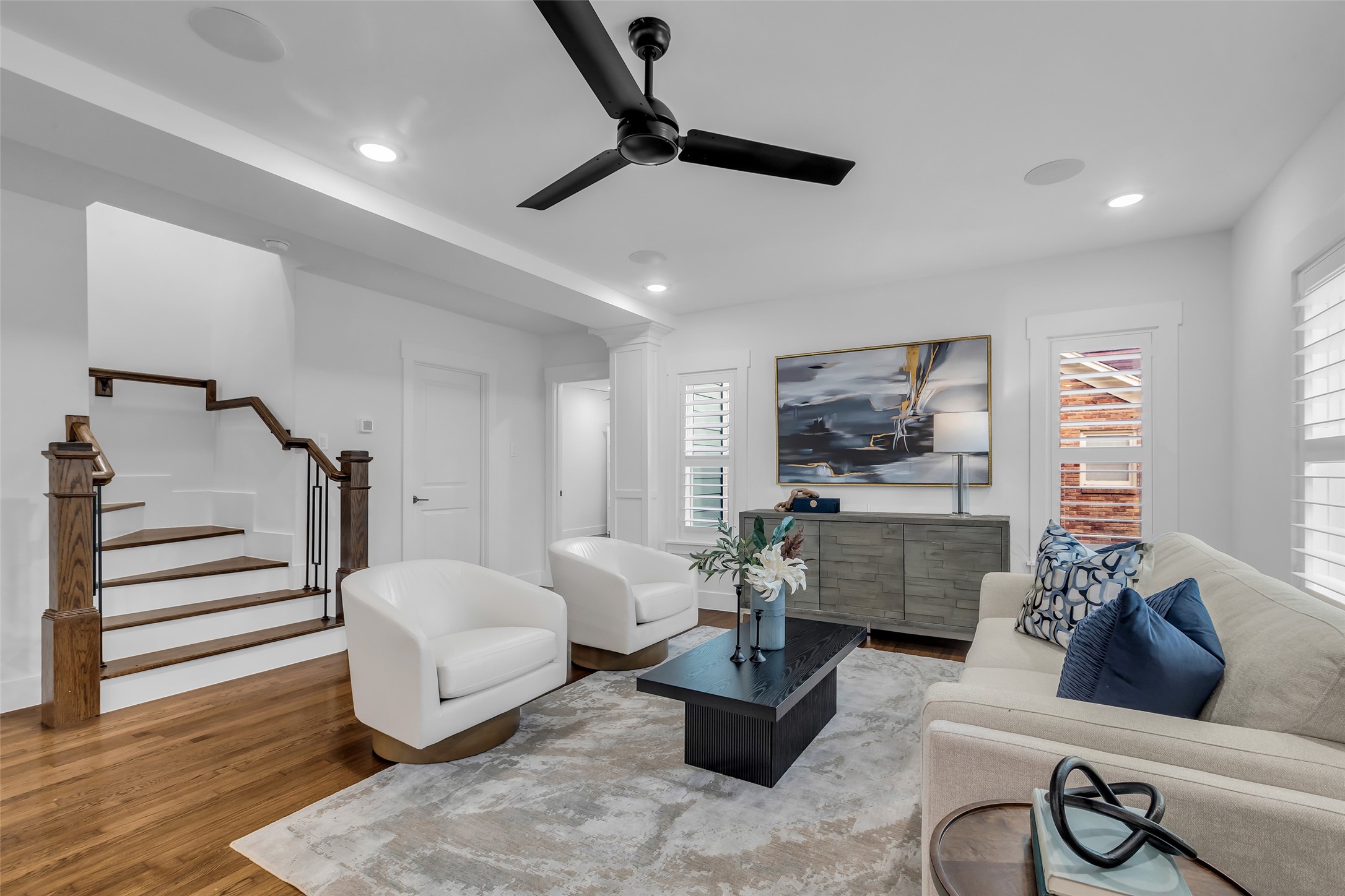 2611 Ruth Street Houston, TX 77004 - Photo 5 of 50 At the corner of the living room, a door leads to the first-floor bathroom, while another provides access to a bedroom, creating a practical and convenient layout for daily living.