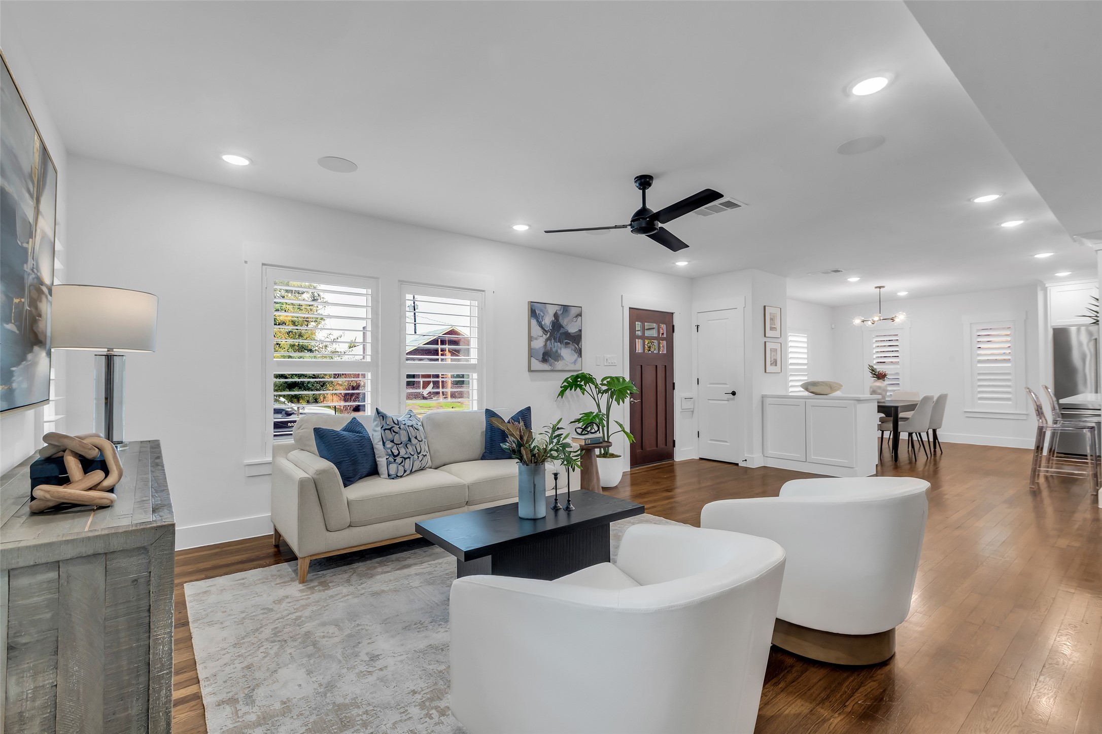2611 Ruth Street Houston, TX 77004 - Photo 6 of 50 From the corner of the living room, this view looks toward the main entrance at the far end. The space faces the front lawn, and the dining area is visible in the distance, creating a clear and connected layout.