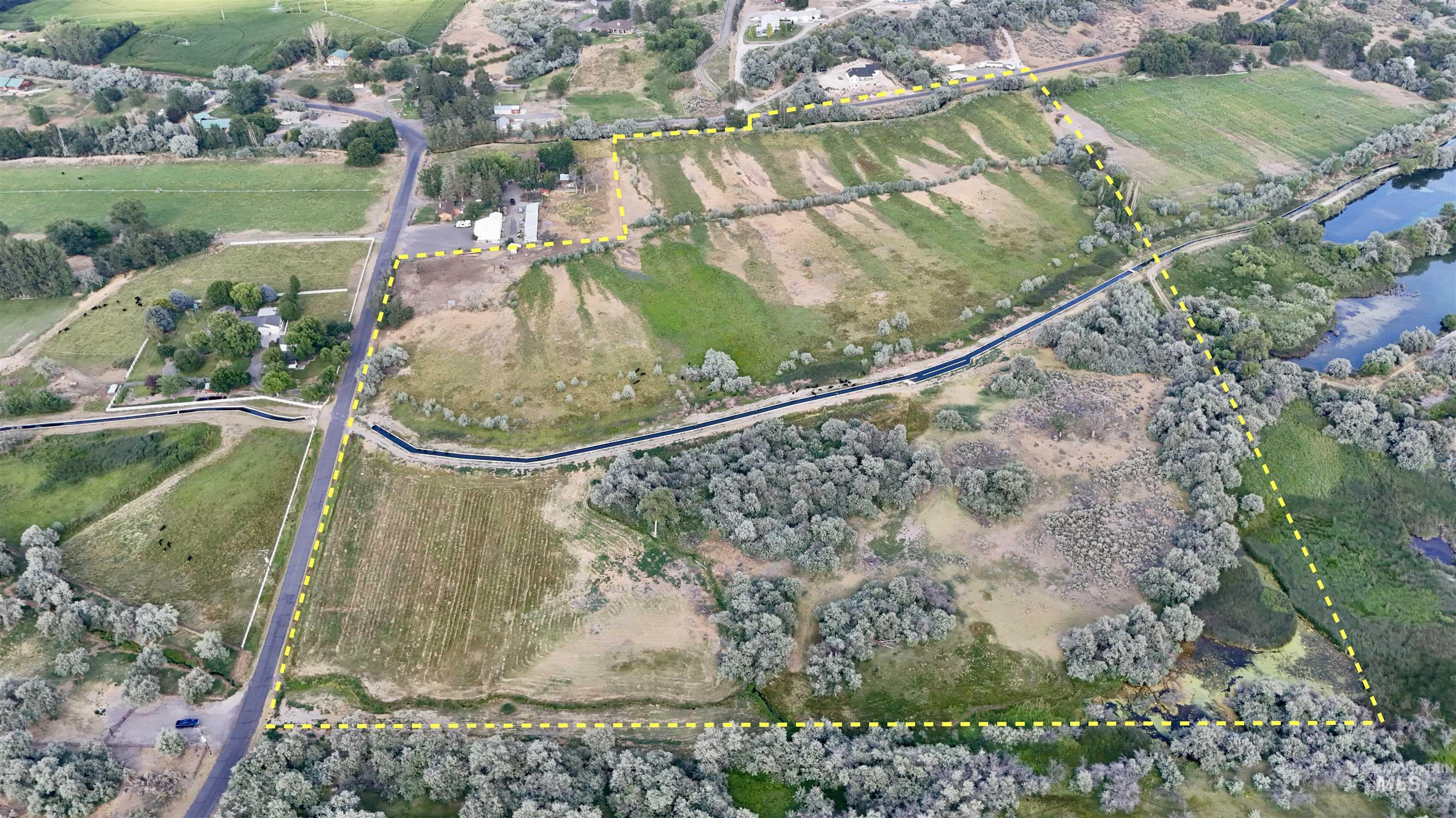 Aerial overview of property's location with property boundaries highlighted and rural landscape