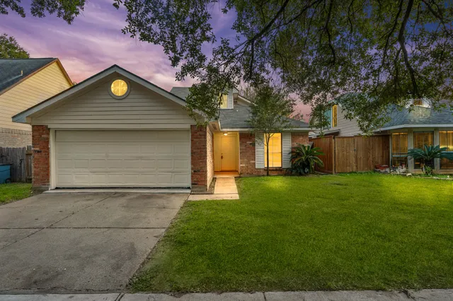 a front view of house with yard and green space