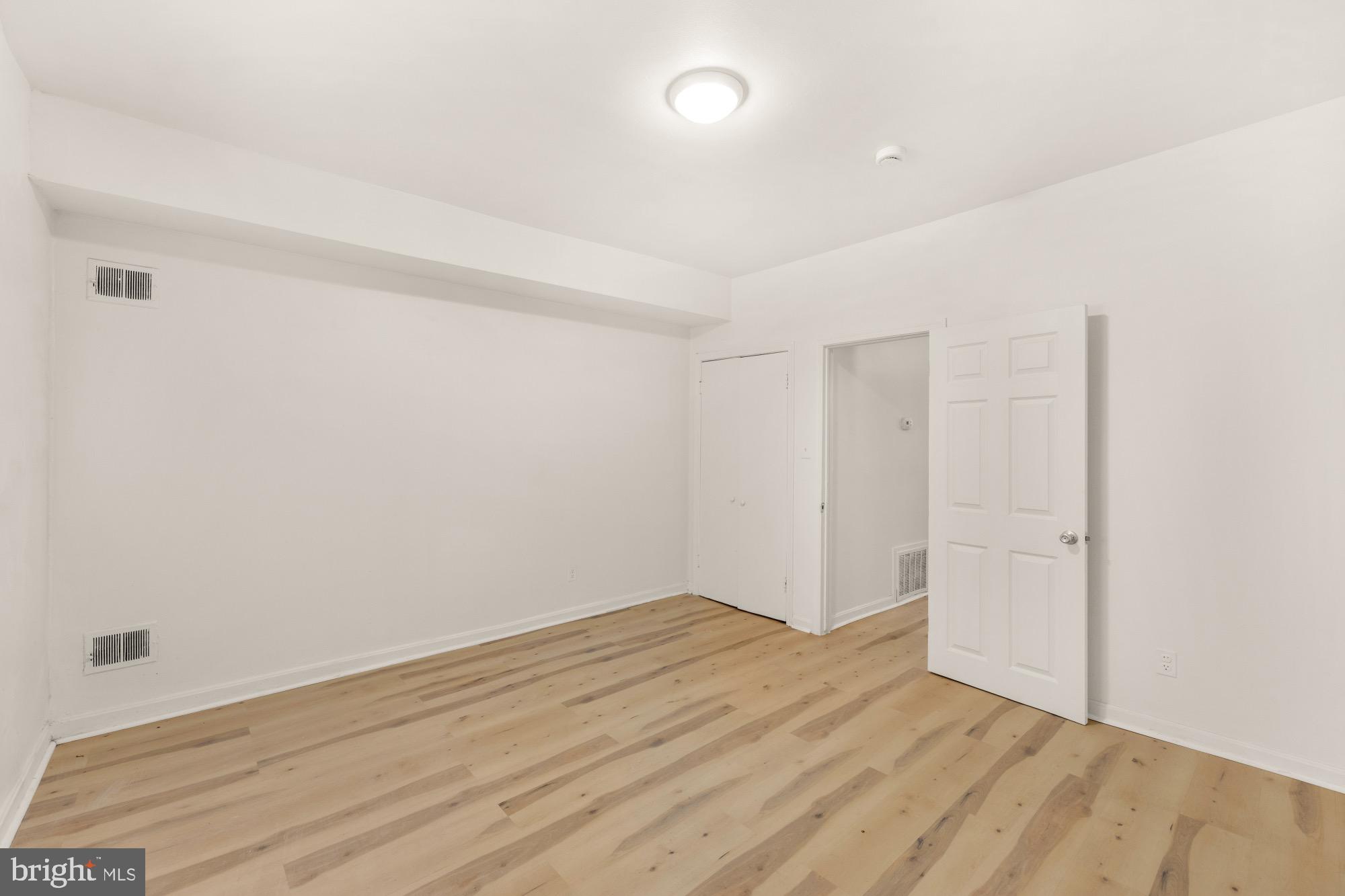 1102 K Street Southeast Washington, DC 20003 - Photo 11 of 30 an empty room with wooden floor and white walls