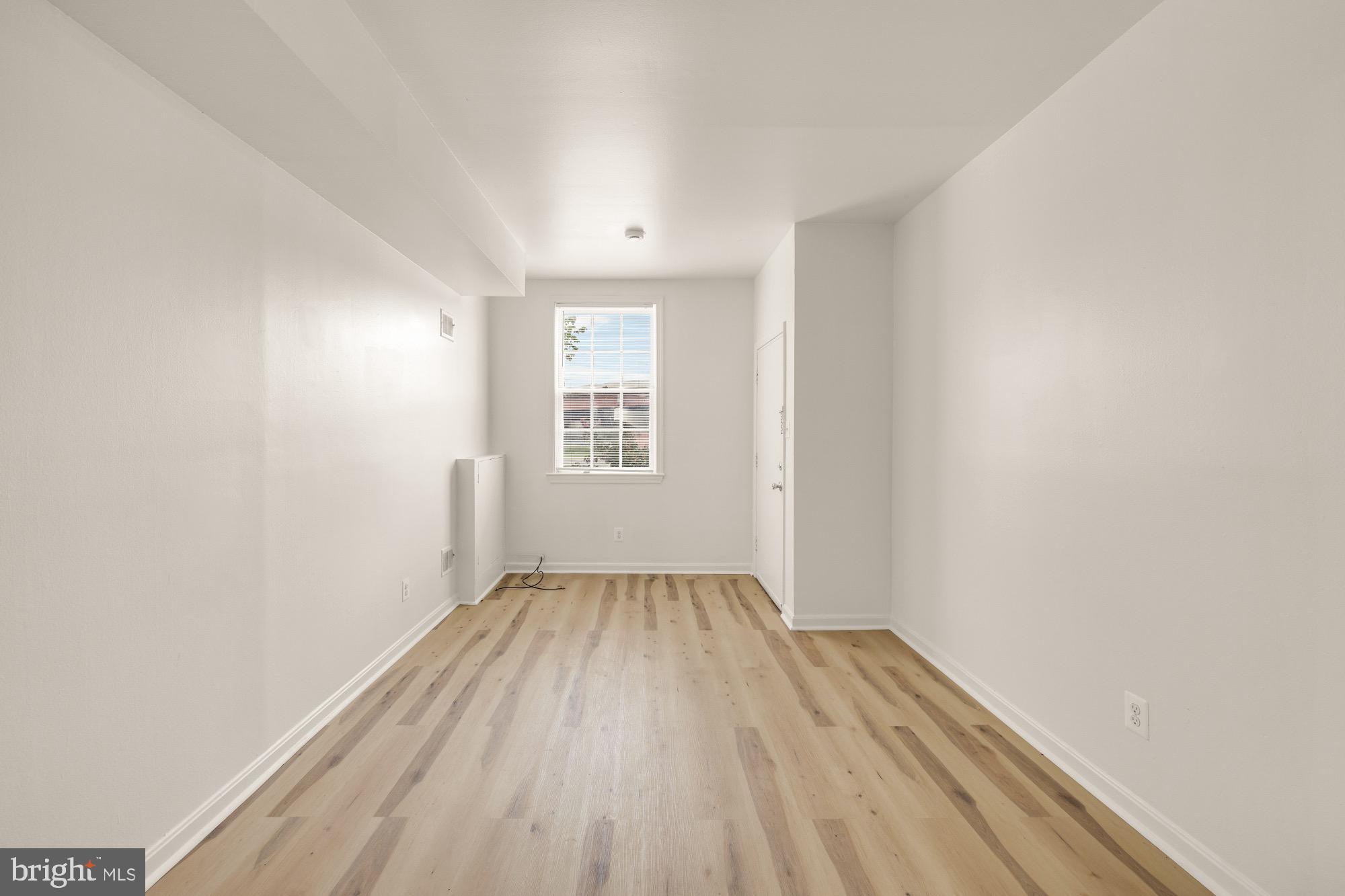 1102 K Street Southeast Washington, DC 20003 - Photo 16 of 30 an empty room with wooden floor and windows