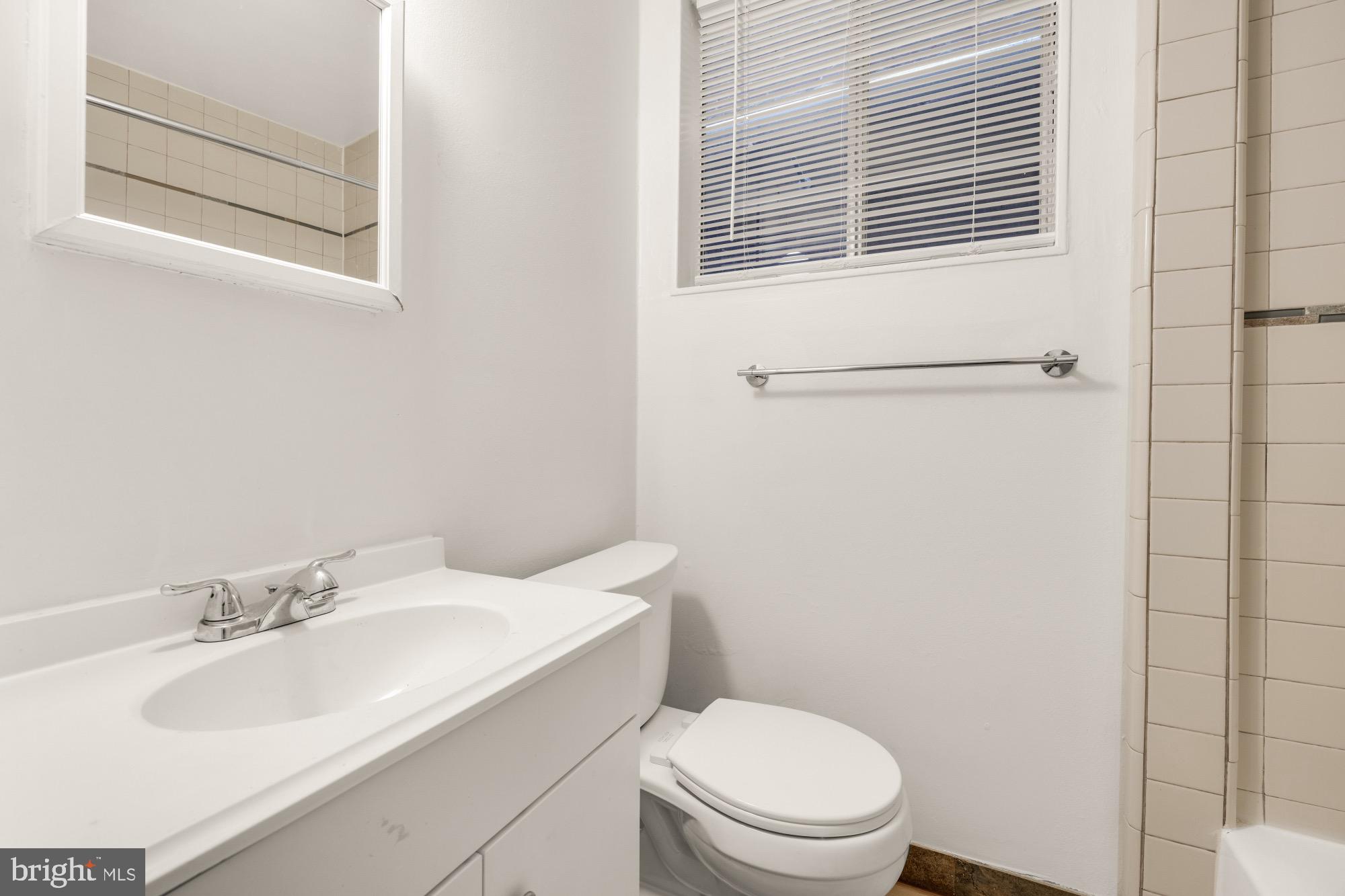 1102 K Street Southeast Washington, DC 20003 - Photo 25 of 30 a bathroom with a sink toilet and mirror
