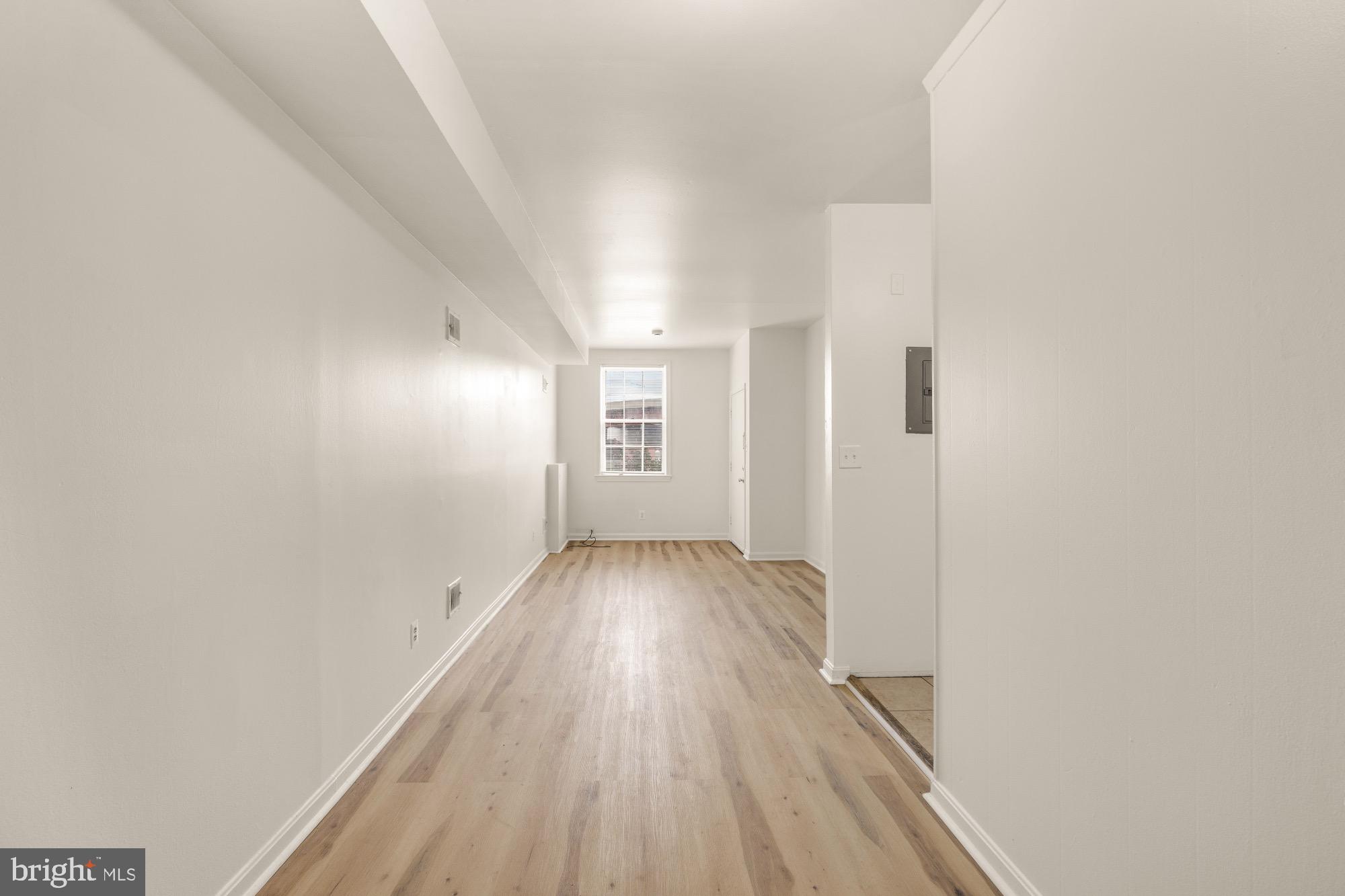 1102 K Street Southeast Washington, DC 20003 - Photo 26 of 30 a view of an empty room with wooden floor and a window