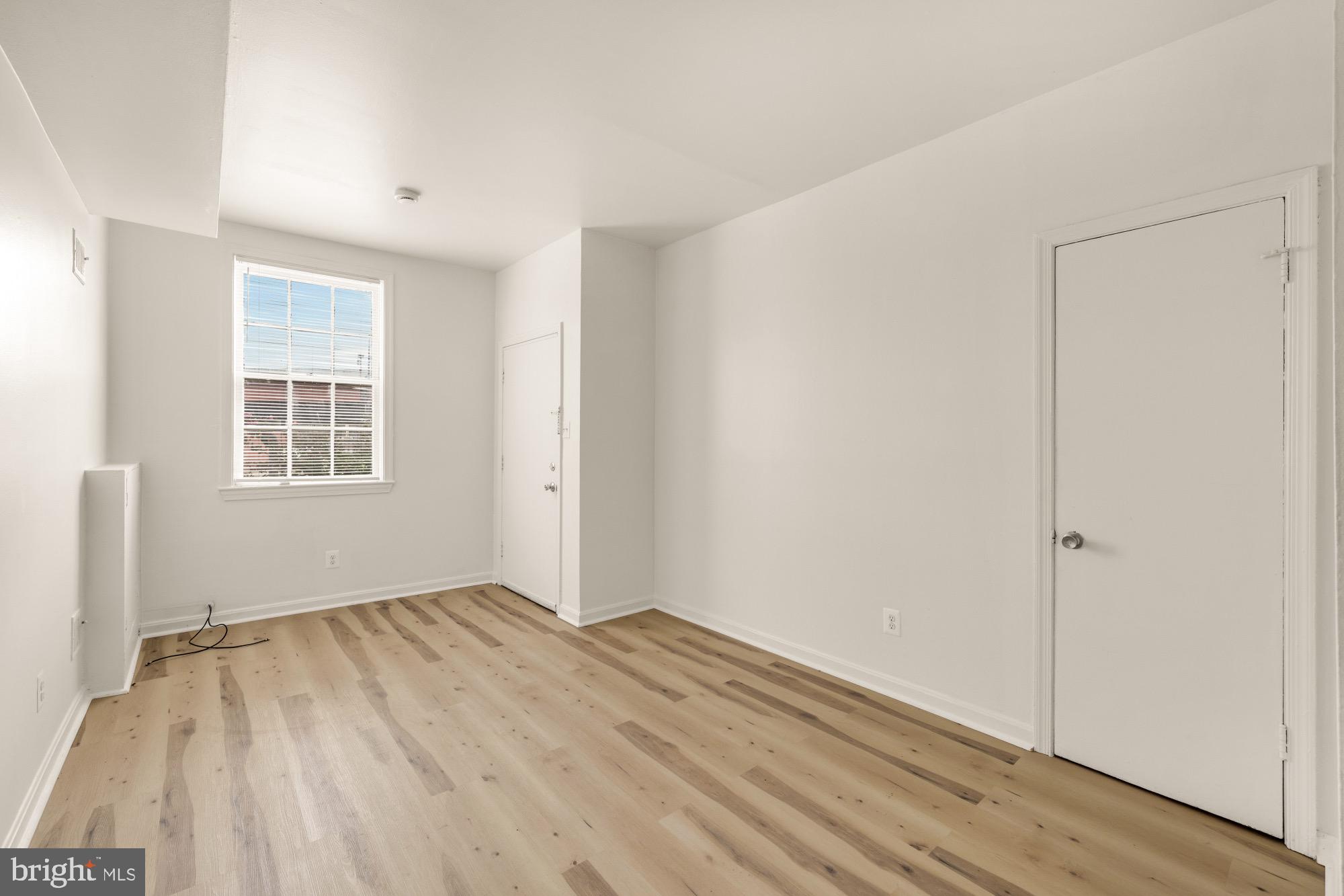 1102 K Street Southeast Washington, DC 20003 - Photo 3 of 30 an empty room with wooden floor and windows