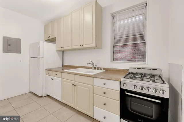 a view of a house with wooden fence