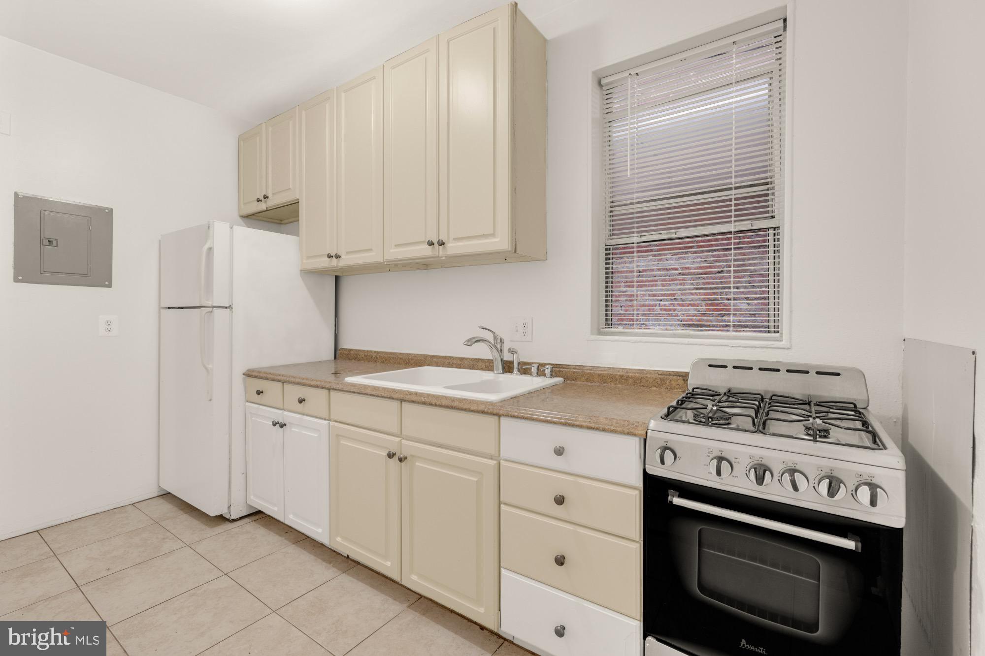 1102 K Street Southeast Washington, DC 20003 - Photo 4 of 30 a kitchen with granite countertop a stove sink and cabinets