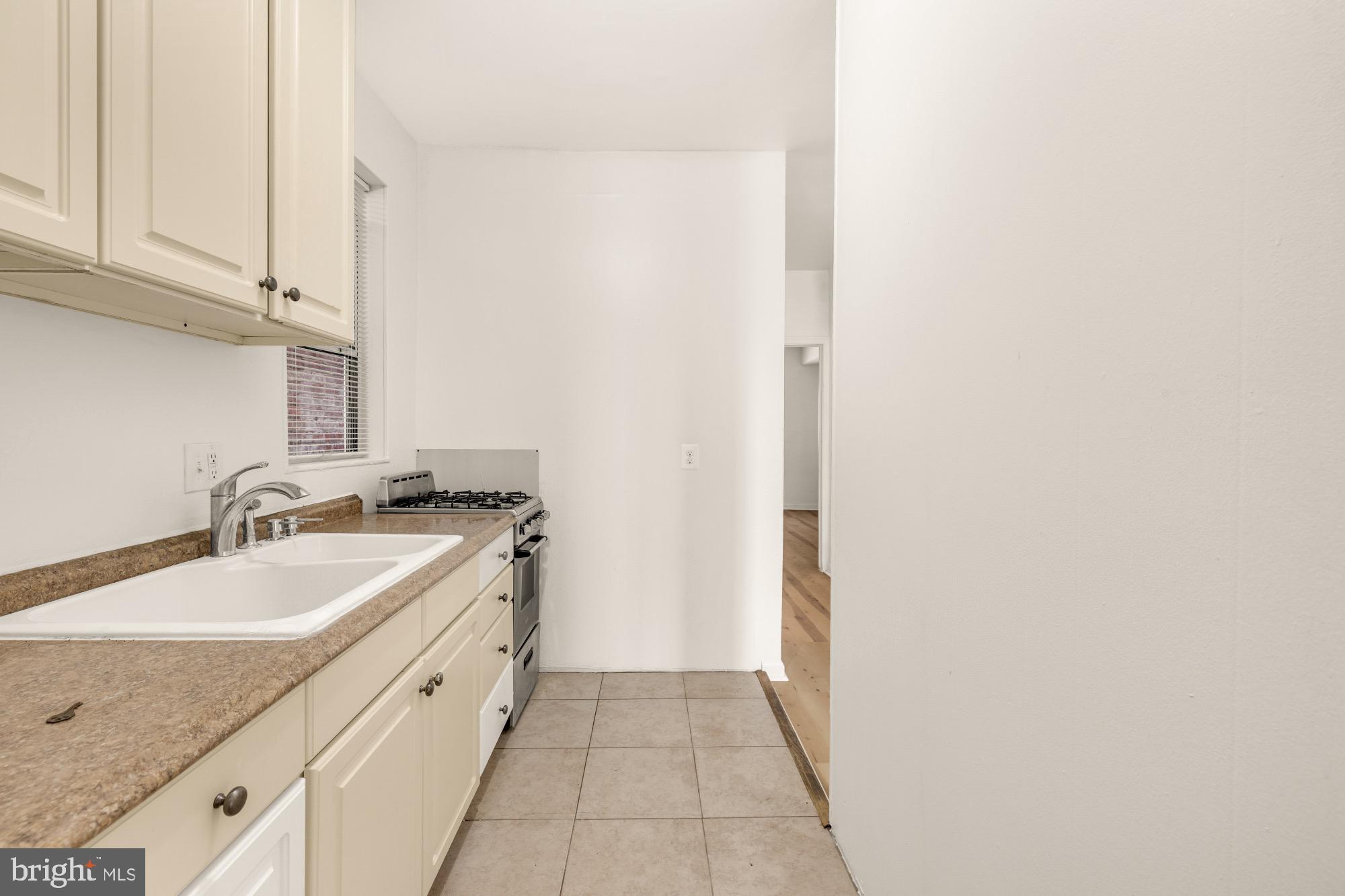 1102 K Street Southeast Washington, DC 20003 - Photo 8 of 30 a bathroom with a granite countertop sink and a mirror