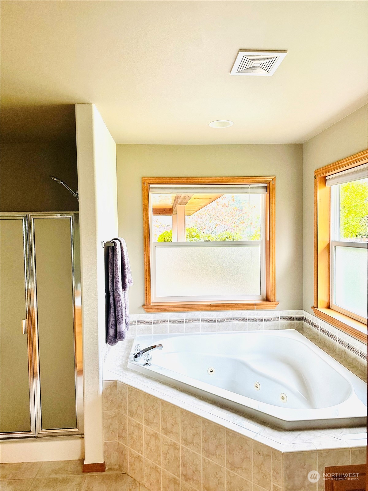 8625 Myrtle Road Northwest Stanwood, WA 98292 - Photo 16 of 23 a bathroom with a tub sink and a window