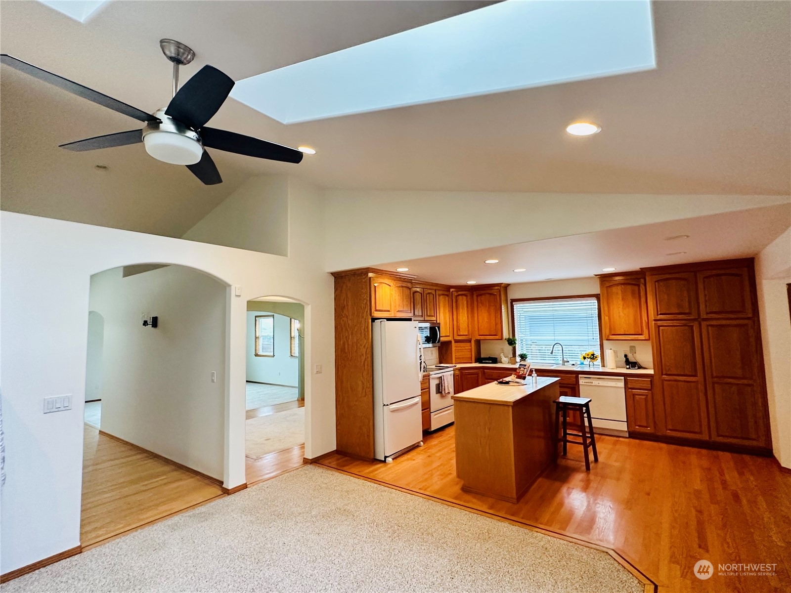 8625 Myrtle Road Northwest Stanwood, WA 98292 - Photo 8 of 23 a kitchen with stainless steel appliances kitchen island granite countertop a refrigerator and a stove top oven