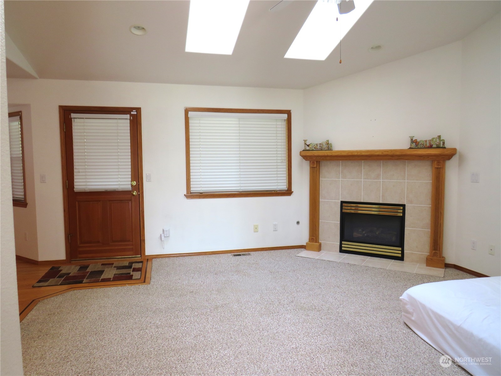 8625 Myrtle Road Northwest Stanwood, WA 98292 - Photo 9 of 23 an empty room with windows and fireplace