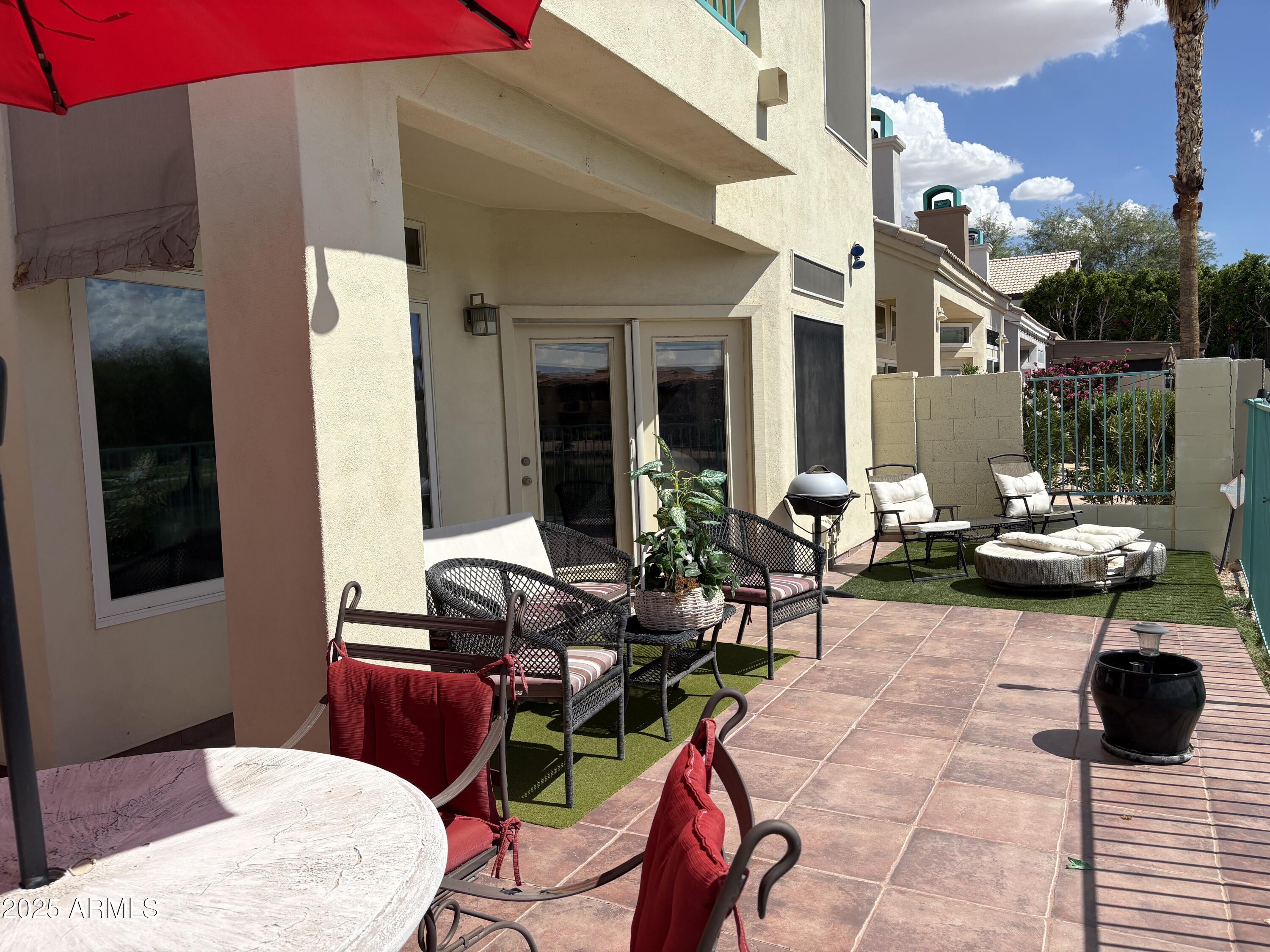 1139 East Frye Road Phoenix, AZ 85048 - Photo 13 of 17 a view of a patio with table and chairs potted plants