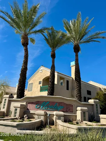 a front view of a house with a fountain