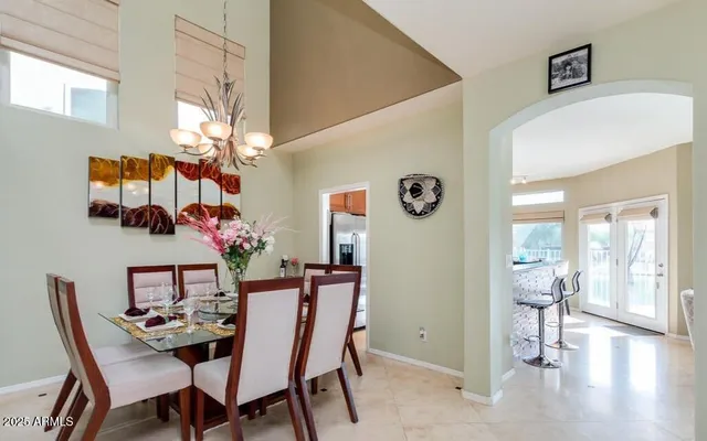 a view of a dining room with furniture and chandelier