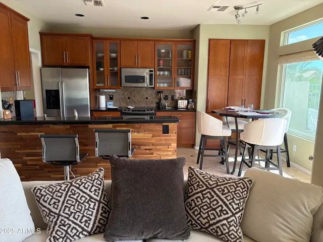 a living room with furniture a rug and a window