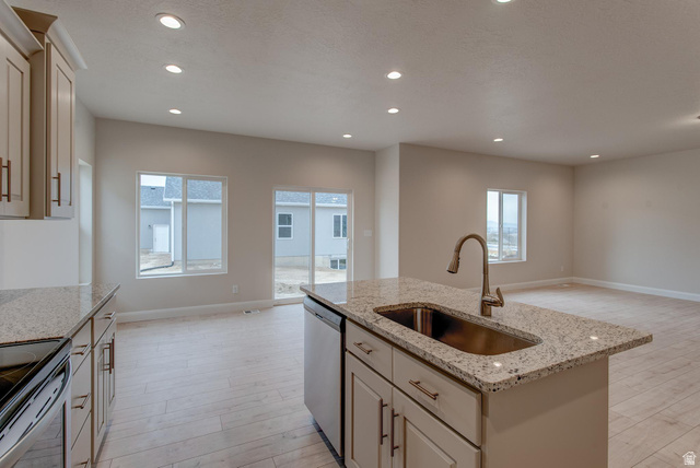 1512 West 600 North, Unit O4A Mapleton, UT 84664 - Photo 4 of 24 Kitchen with an island with sink, light stone countertops, dishwasher, light wood-style flooring, and recessed lighting