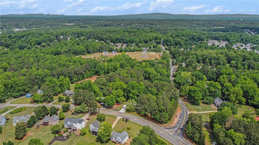 3852 Drew Campground Road Cumming, GA 30040 - Photo 11 of 41 an aerial view of green landscape with trees houses and mountain view
