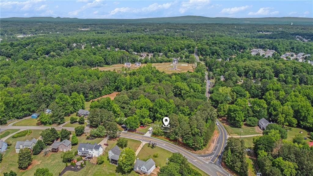 3852 Drew Campground Road Cumming, GA 30040 - Photo 14 of 41 an aerial view of green landscape with trees houses and mountain view