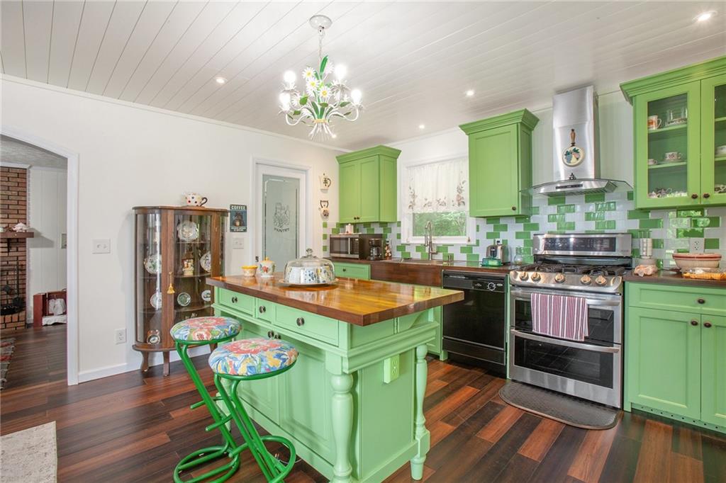 3852 Drew Campground Road Cumming, GA 30040 - Photo 25 of 41 a kitchen with kitchen island stainless steel appliances a stove and a table