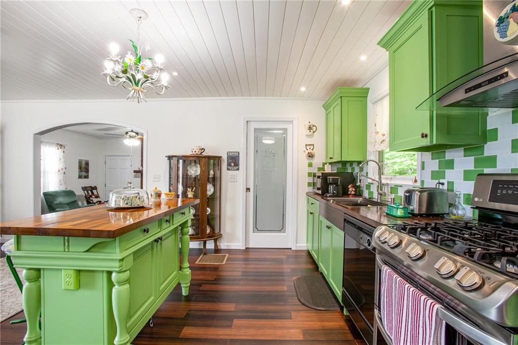 3852 Drew Campground Road Cumming, GA 30040 - Photo 26 of 41 a kitchen filled with stainless steel appliances granite countertop a stove a sink dishwasher and a dining table
