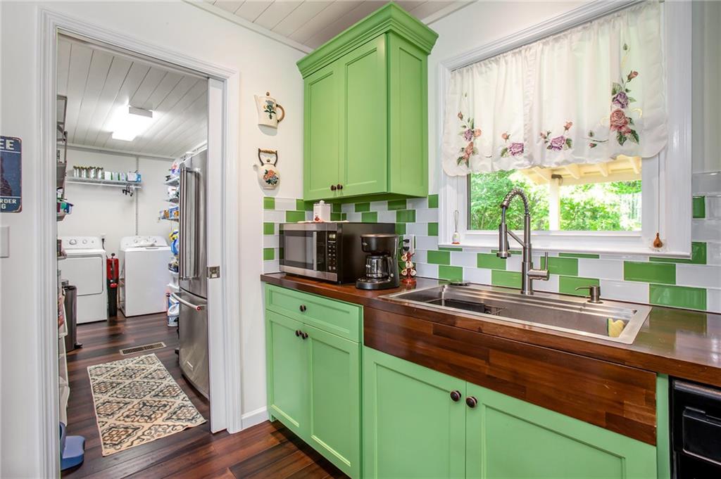 3852 Drew Campground Road Cumming, GA 30040 - Photo 27 of 41 a kitchen with kitchen island granite countertop a sink a counter top space and cabinets