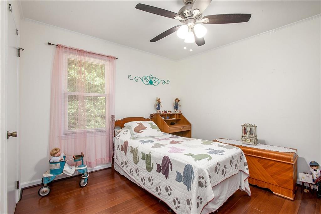 3852 Drew Campground Road Cumming, GA 30040 - Photo 33 of 41 a bedroom with a bed and a chandelier
