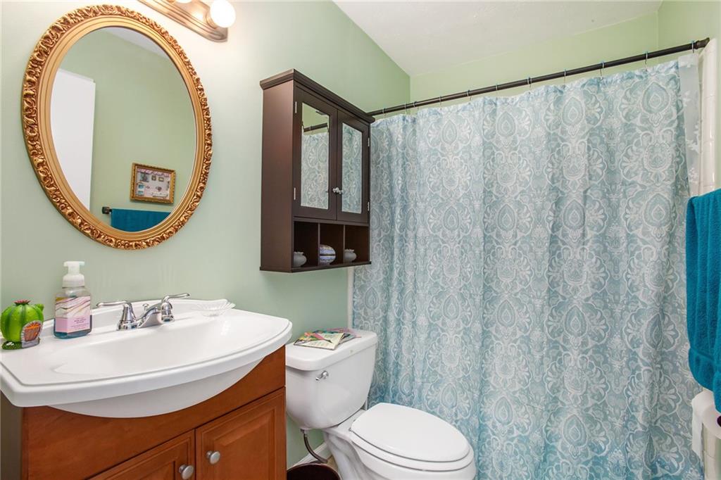 3852 Drew Campground Road Cumming, GA 30040 - Photo 35 of 41 a bathroom with a sink a mirror and a toilet