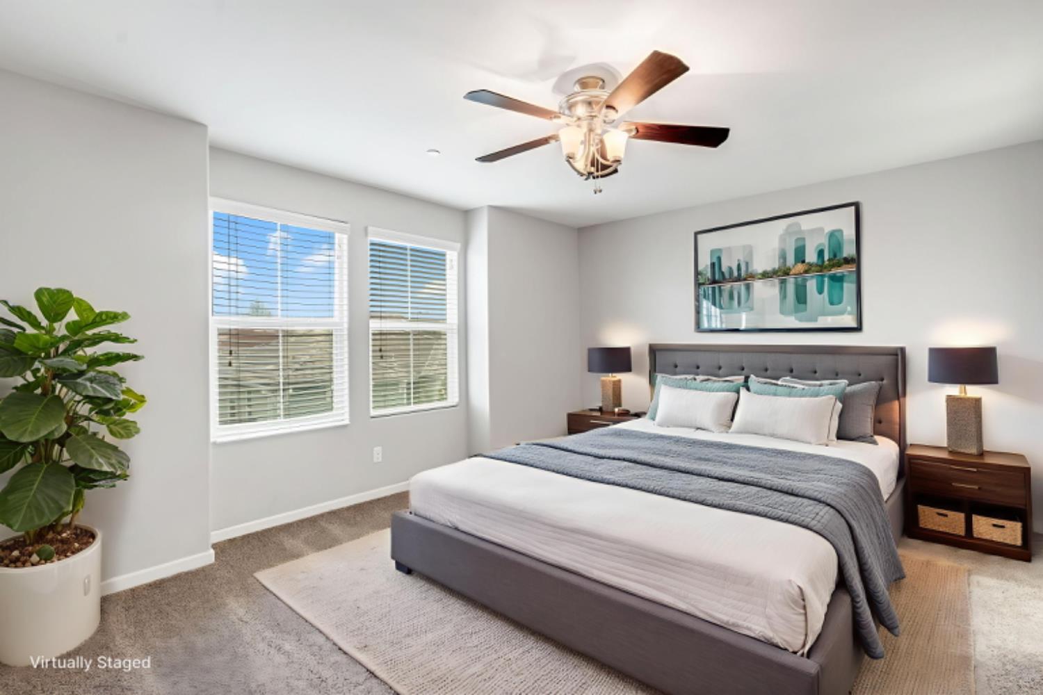 a spacious bedroom with a large bed and a potted plant