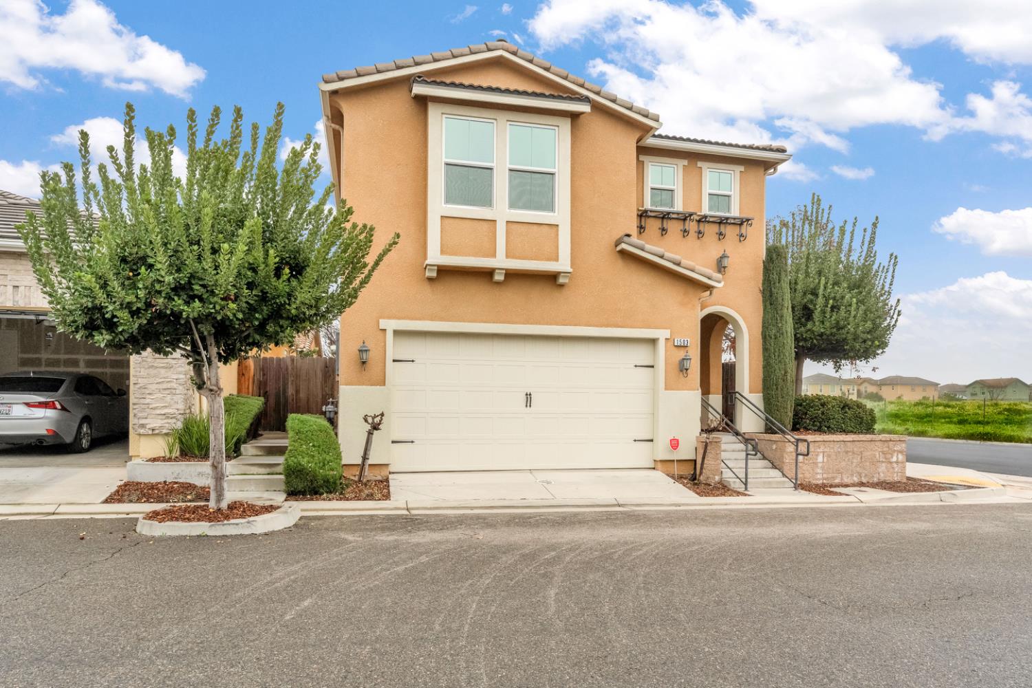 1503 North Reunion Way Clovis, CA 93619 - Photo 10 of 25 a front view of a house with a yard and garage