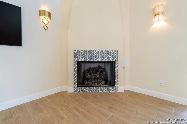 a view of an empty room and wooden floor