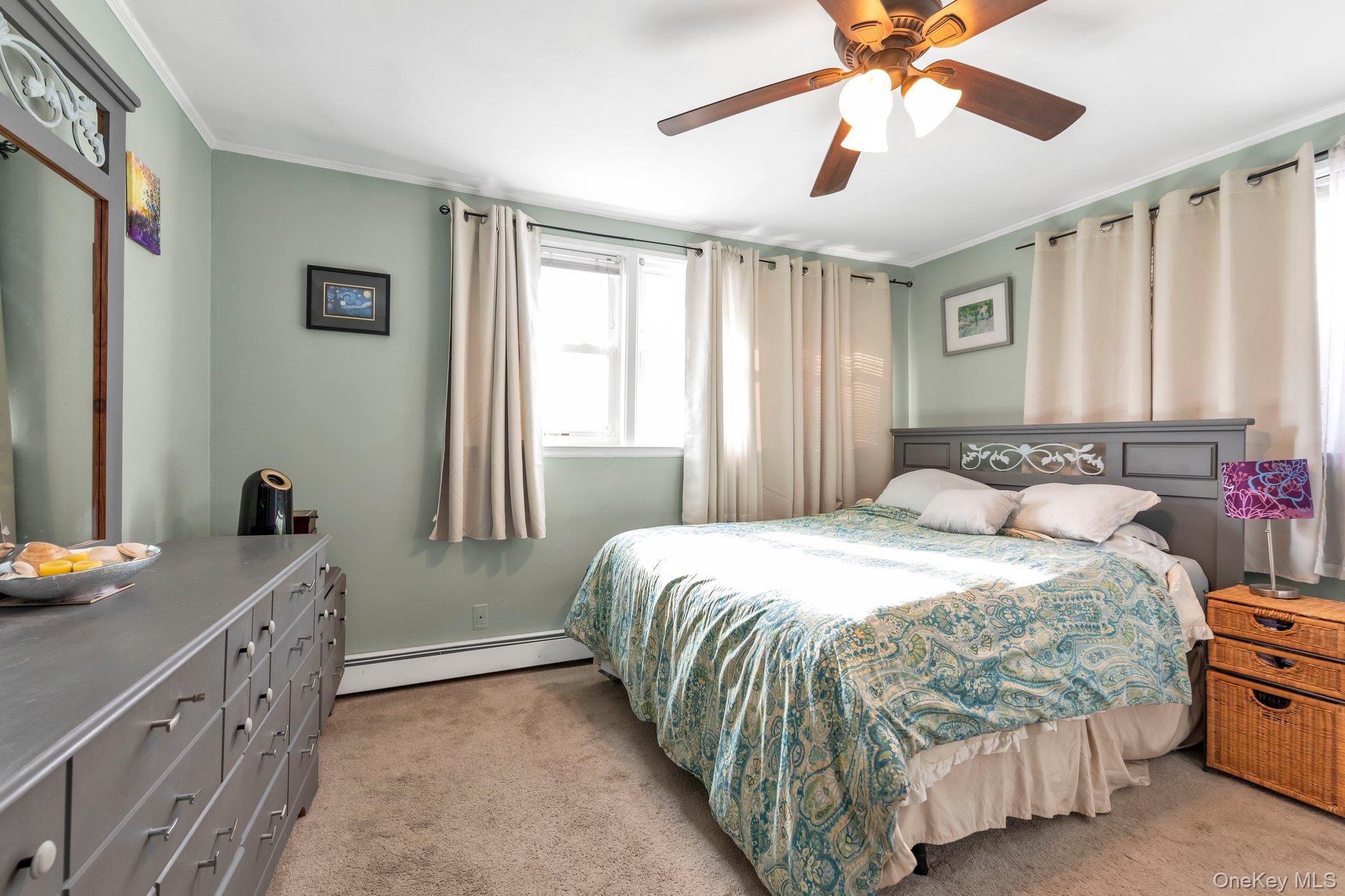 412 Wellington Road East Meadow, NY 11554 - Photo 11 of 15 a bedroom with a bed and a window
