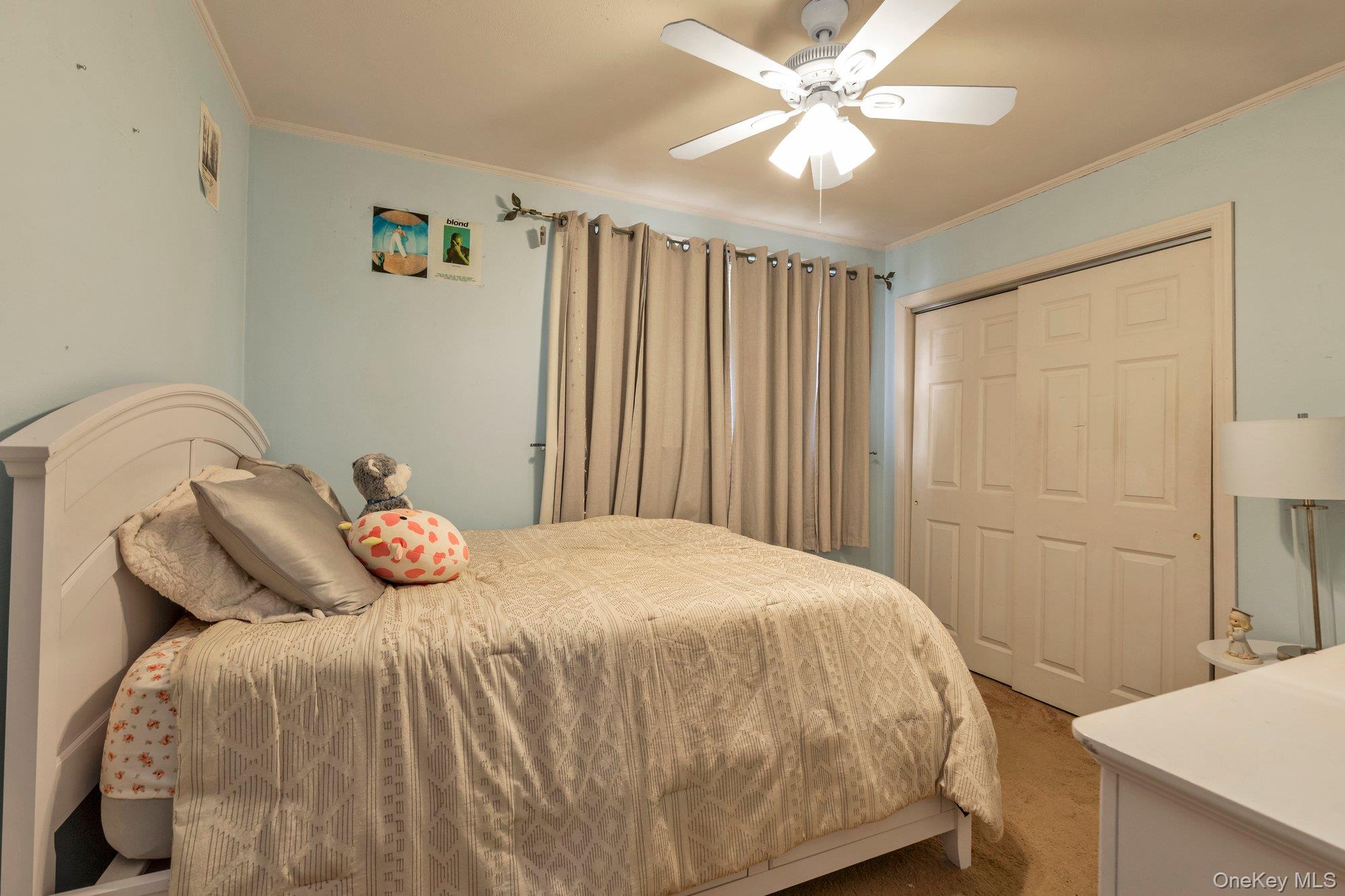 412 Wellington Road East Meadow, NY 11554 - Photo 12 of 15 a bedroom with a bed and a table