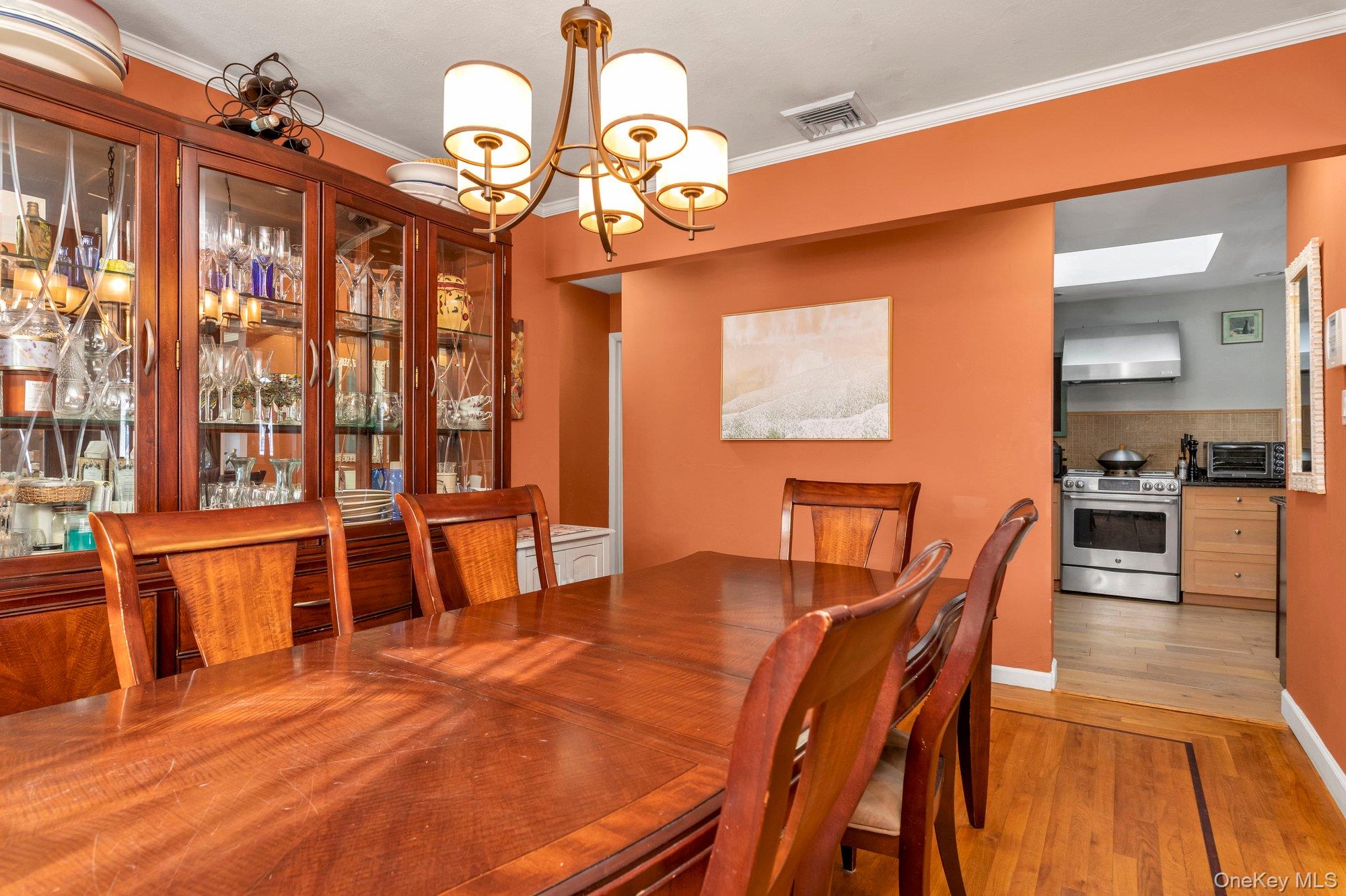 412 Wellington Road East Meadow, NY 11554 - Photo 6 of 15 a dining room with furniture a chandelier and wooden floor