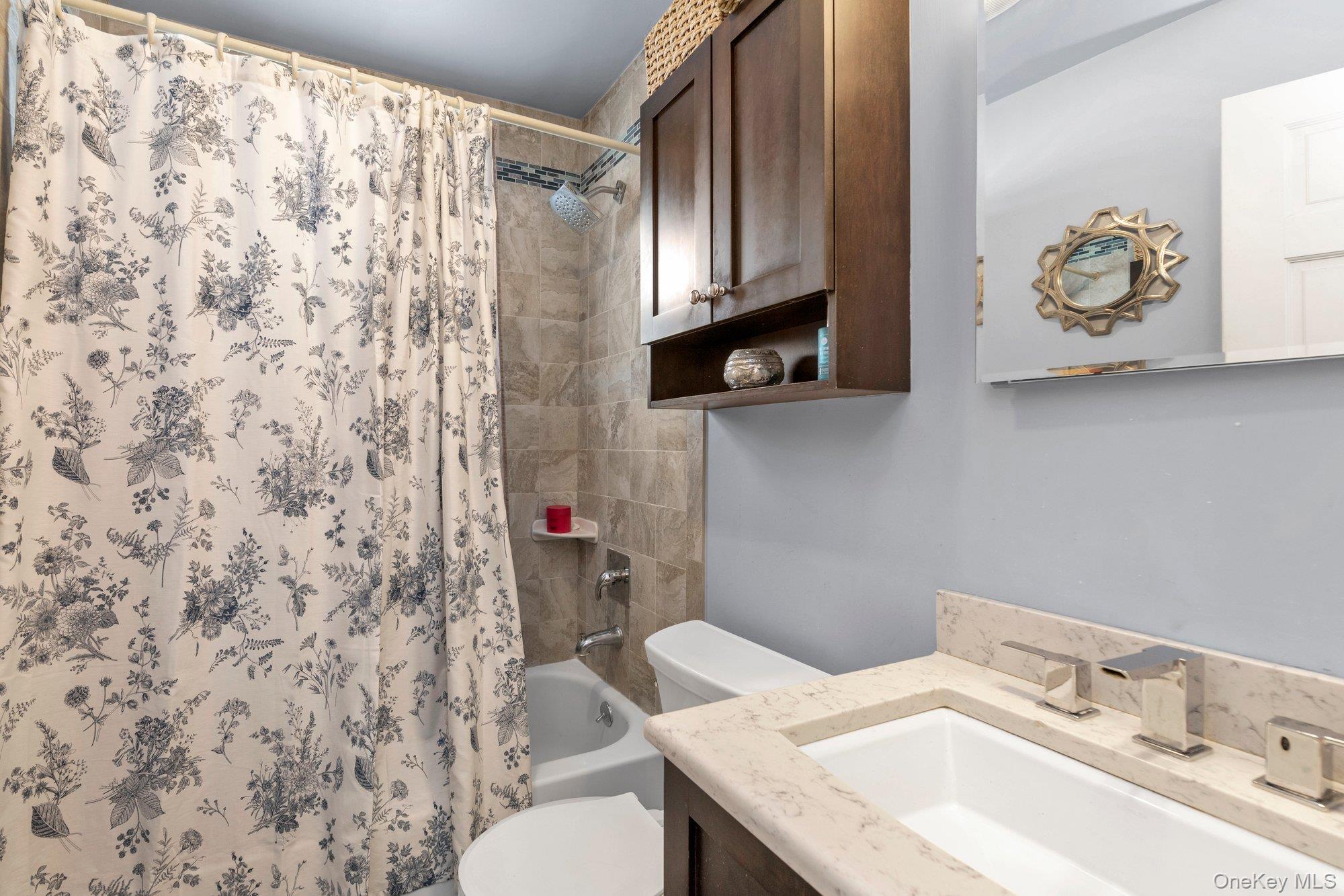 412 Wellington Road East Meadow, NY 11554 - Photo 10 of 15 a bathroom with a sink toilet and mirror