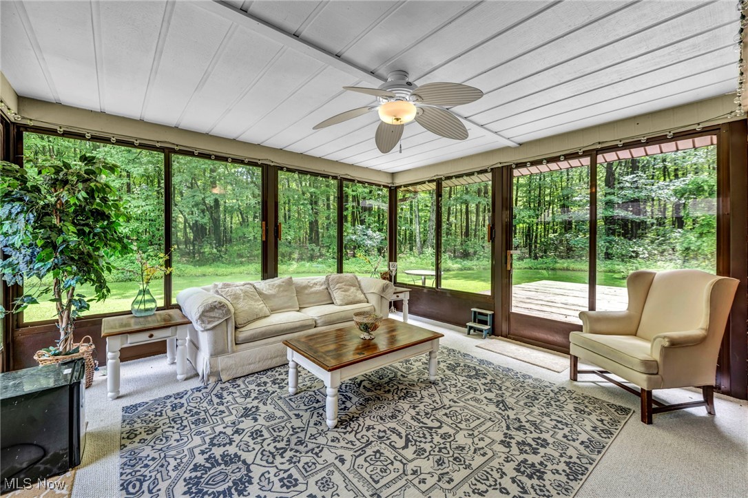 12938 Carter Road Painesville, OH 44077 - Photo 21 of 50 Sunroom featuring ceiling fan and an outdoor hangout area