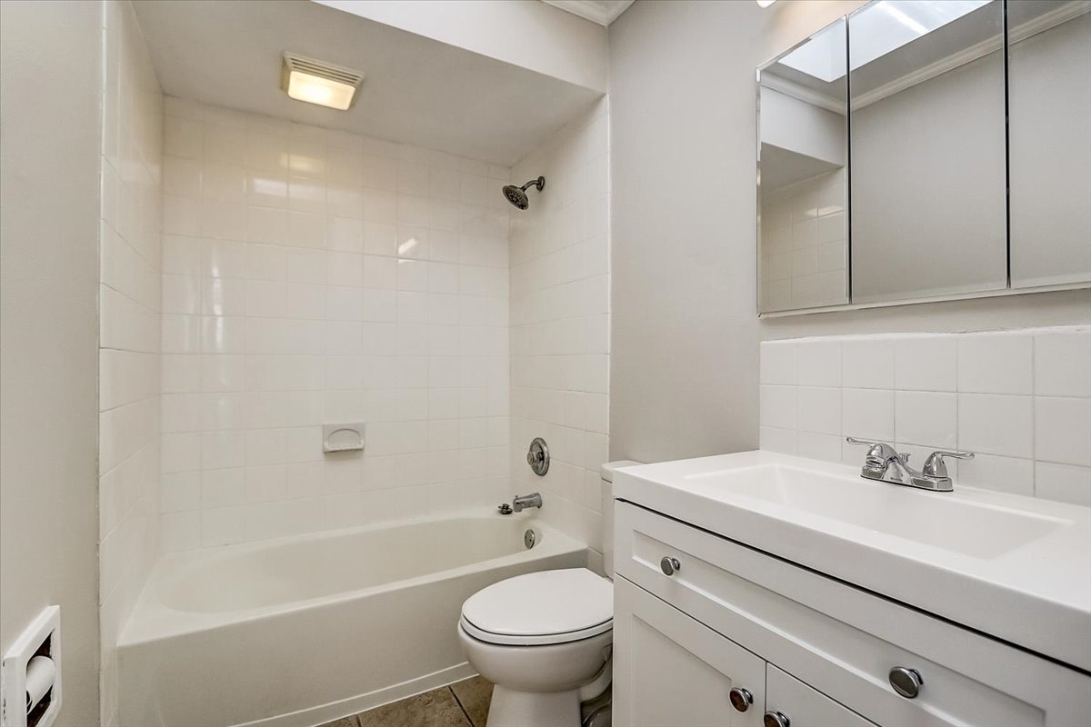 S041 Page Street Winfield, IL 60190 - Photo 12 of 32 a bathroom with a sink a toilet and a bathtub