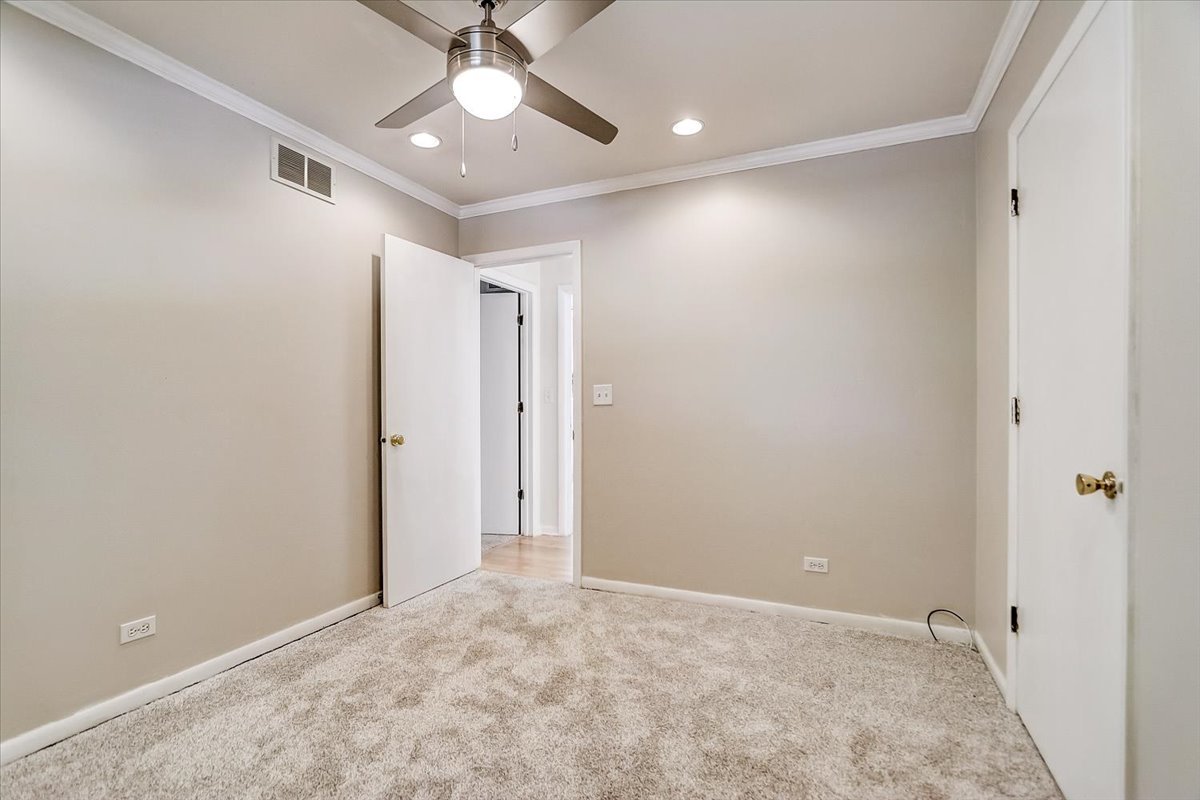 S041 Page Street Winfield, IL 60190 - Photo 16 of 32 an empty room with fan and entrance