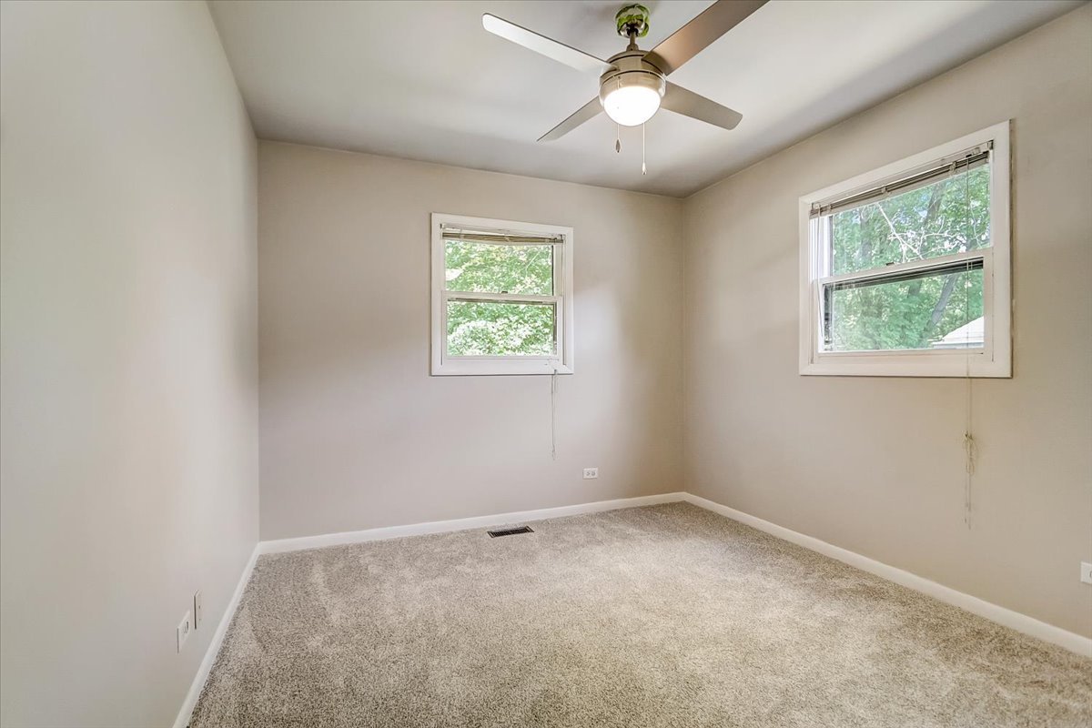 S041 Page Street Winfield, IL 60190 - Photo 17 of 32 an empty room with a window and a fan