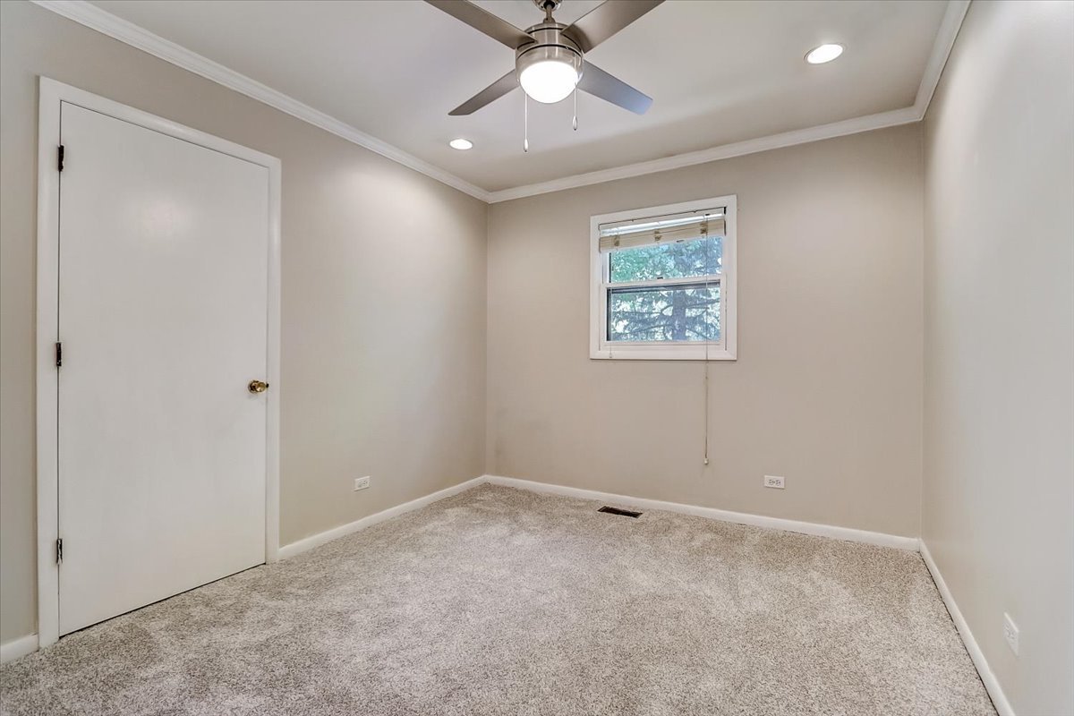 S041 Page Street Winfield, IL 60190 - Photo 24 of 32 an empty room with windows and fan