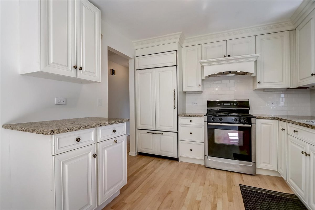 S041 Page Street Winfield, IL 60190 - Photo 10 of 32 a kitchen with white cabinets and stainless steel appliances
