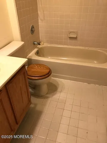 a bathroom with a toilet a sink and bathtub