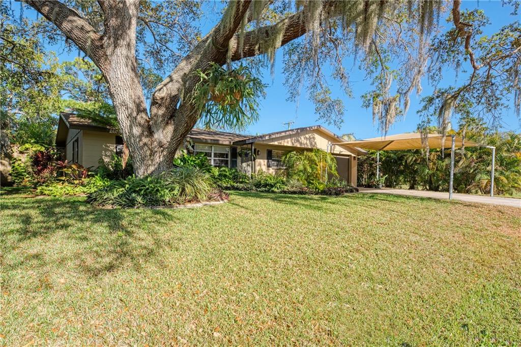 2411 Gentian Road Venice, FL 34293 - Photo 1 of 1 a front view of a house with a yard