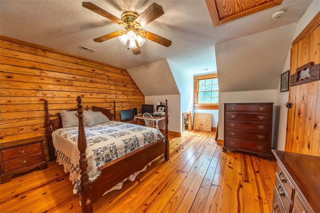 846 Twiggs Ferry Road Hartfield, VA 23071 - Photo 10 of 28 Bedroom with wood-type flooring, a textured ceiling, ceiling fan, and lofted ceiling
