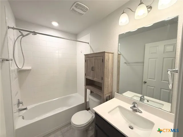 a bathroom with a sink toilet tub and shower