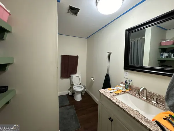 a bathroom with a toilet sink and mirror