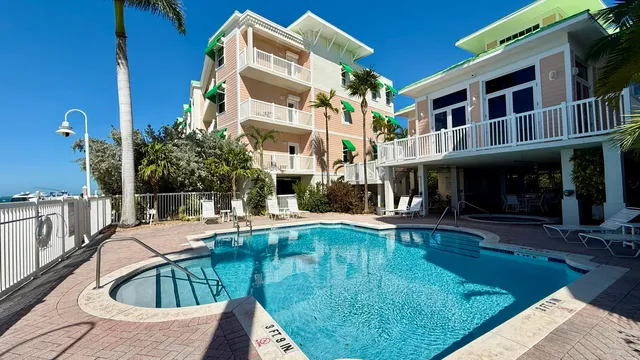 a view of a house with swimming pool and sitting area