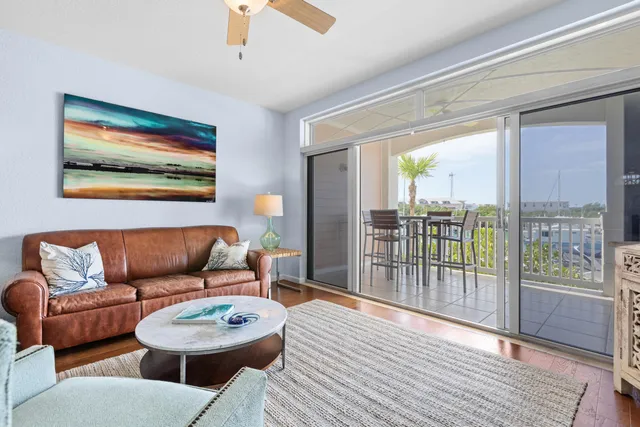a living room with furniture a lamp and wooden floor